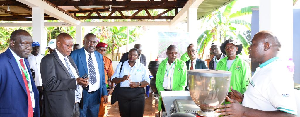 Dr. Mukulu Fred, the Mukono District Production Officer together with some staff showing the guest of honor the exhibition.